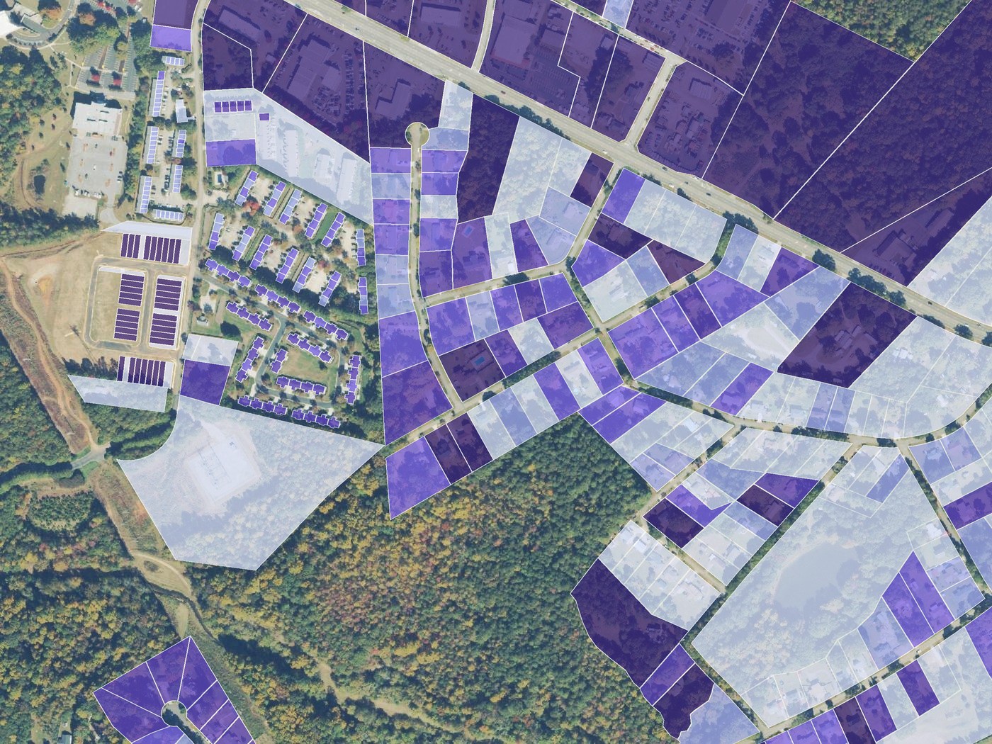 Parcels shaded by assessed value from pale to deep purple over aerial imagery